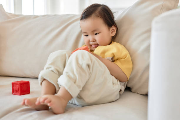 istock Little girl playing toys on sofa 1496663036