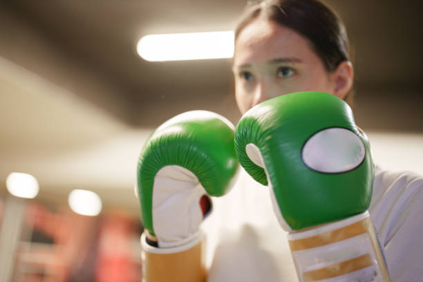 Young woman boxing exercises with her trainer