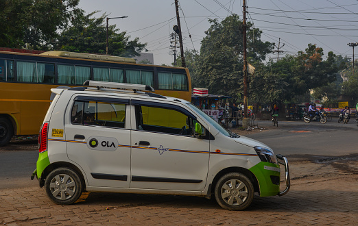 Agra, India - Nov 13, 2017. Ola car on street in Agra, India. Agra is included on the Golden Triangle tourist circuit, along with Delhi and Jaipur.