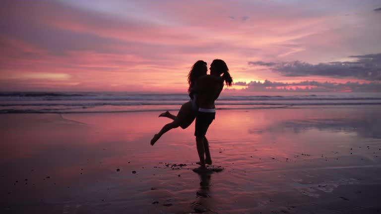 Couple Of People In Love At Sea Beach Sunset And Ocean Water. Modern Caucasian Family Of Two Lovers Embracing In Dance Or Hugging. Beauty Concept Of Healthy Pretty Woman And Attractive Handsome Man