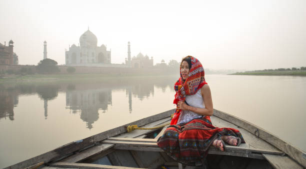 istock A woman watching sunset over Taj Mahal 1496669678