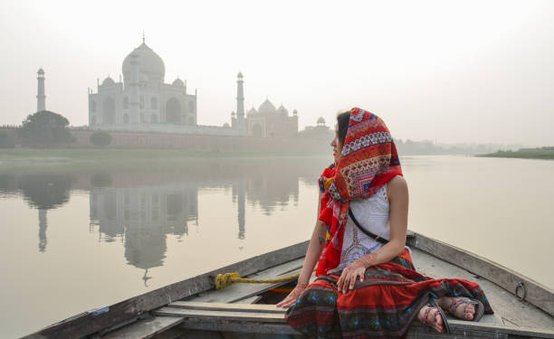 istock A woman watching sunset over Taj Mahal 1496669686