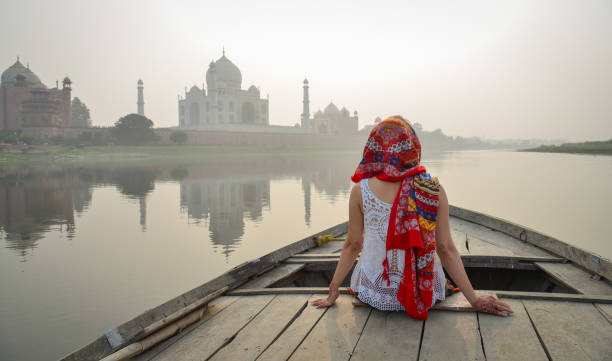 istock A woman watching sunset over Taj Mahal 1496669688