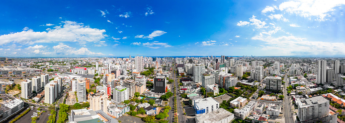 Aerial panorama above Abraham Lincoln street in the city center. Skyscrapers and office buildings in downtown of Santo Domingo Dominican Republic. High quality photo