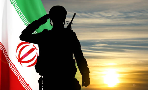 istock Silhouette of a saluting soldier against the sunset with Iran flag 1496681007