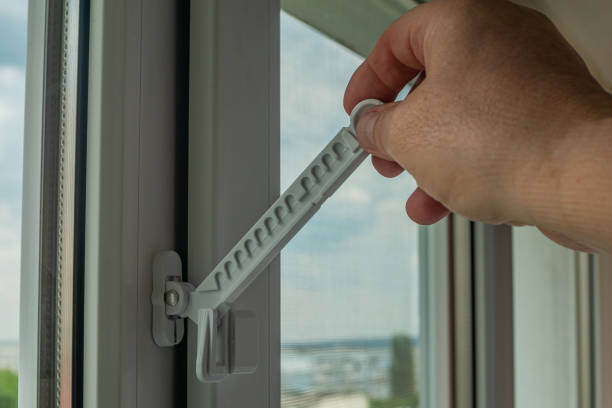 istock Close-up of a man's hand adjusting a window opening limiter. Window stop adjustment on a plastic window frame. Modern accessories of plastic windows. Modern window frames 1496684975