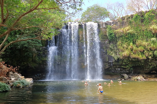 March 10 2023 - Bagaces, Guanacaste in Costa Rica: People enjoy playing and swimming at Llanos the Cortes waterfall in Bagaces