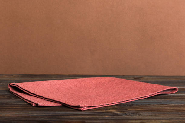 istock top view with red empty kitchen napkin isolated on table background. Folded cloth for mockup with copy space, Flat lay. Minimal style 1496686099