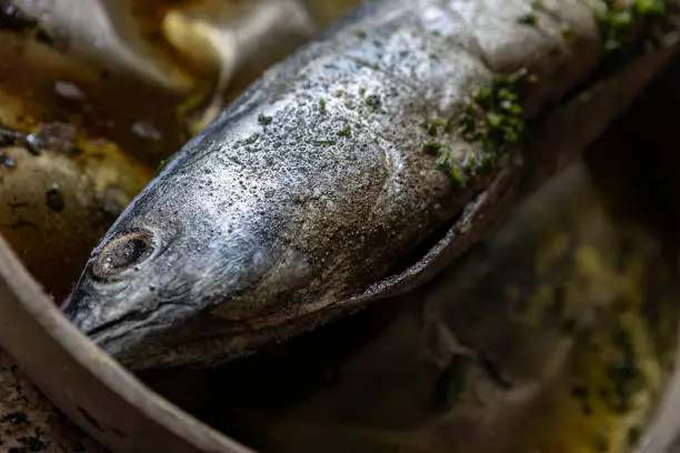 A video clip showing the seasoning and preparation of tonnarella fish for cooking.