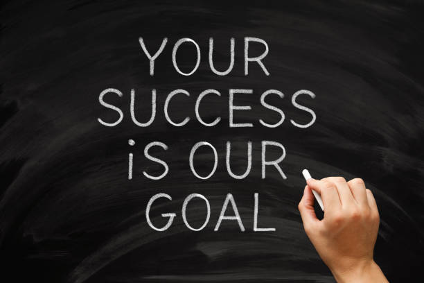 Your Success Is Our Goal Inspirational Leadership Quote Hand writing inspirational quote Your Success Is Our Goal on blackboard. Concept about leadership, partnership, cooperation, or collaboration. teamwork slogan stock pictures, royalty-free photos & images