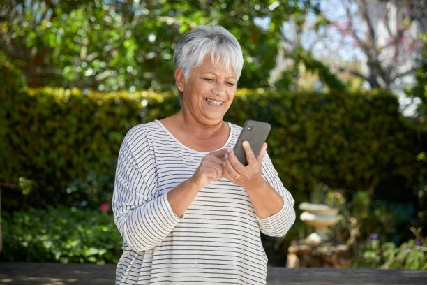 istock Beautiful senior woman using her cellphone 1496691865