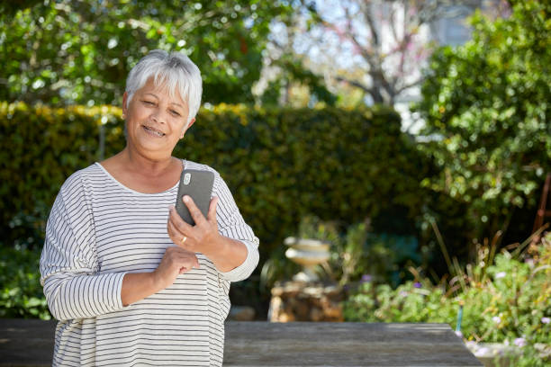 istock Beautiful senior woman using her cellphone 1496691975