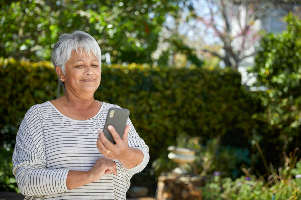 istock Beautiful senior woman using her cellphone 1496692131