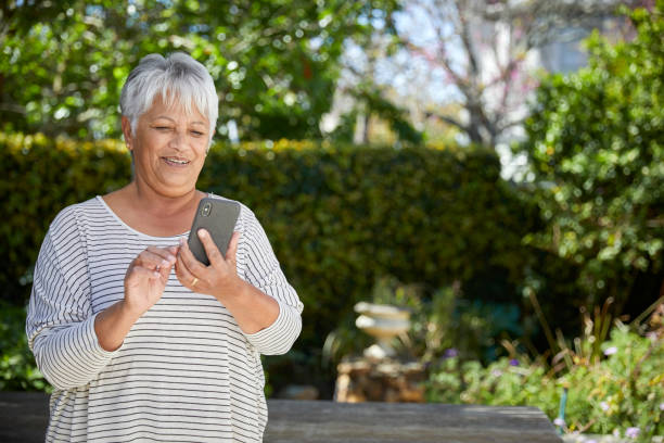 istock Beautiful senior woman using her cellphone 1496692137