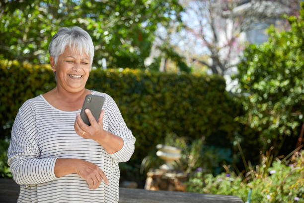 istock Beautiful senior woman using her cellphone 1496692151
