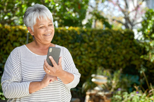 istock Beautiful senior woman using her cellphone 1496692198