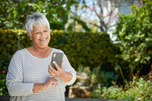 istock Beautiful senior woman using her cellphone 1496692288