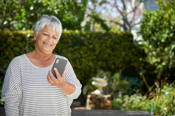 istock Beautiful senior woman using her cellphone 1496692296
