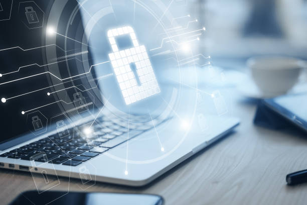 istock Close up of laptop computer on desktop with glowing circuit padlock hologram on blurry background. Secure and safety concept. Double exposure. 1496693454