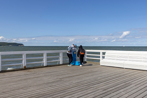 Sopot, Poland - June 2, 2023: People on wooden Sopot pier in the Gulf of Gdansk in the Baltic Sea in sunny day. It is the longest wooden pier in Europe, 511,5 m long