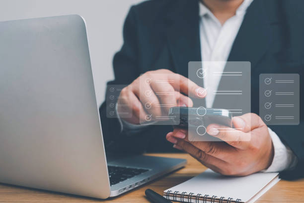 istock Business performance checklist, Quick checklist and clipboard management concept, job applicants, businessman using laptop doing online checklist survey,Employees must complete the online survey form. 1496695174
