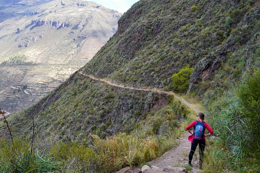 Pisac, Peru - June 22, 2017: Woman hiking in the sacred valley footpaths