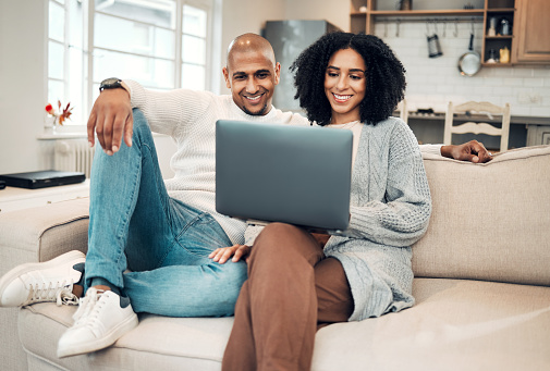 Couple, laptop and video call, communication and happy people at home, technology and virtual chat. Internet, connection and network, man and woman relax in living room with online conversation