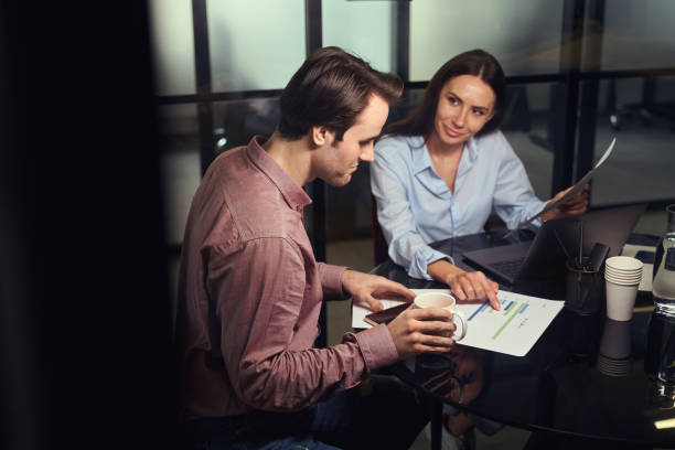istock Two office workers dealing with documentation at business meeting 1496700798