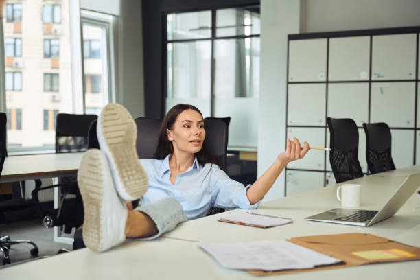 istock Serious female boss having conversation with employee in open-plan office 1496700917