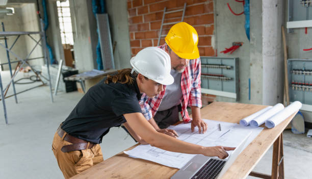 istock Female Architect And Male Construction Worker 1496703080
