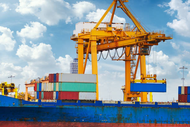 istock Container ship vessel docked to an international commercial port , transportation and loading/unloading logistic . 1496704333