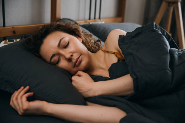 istock Serene sleeping woman sleeping in an orthopedic bed 1496704752
