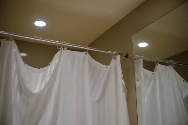 istock Plastic curtain serves as a shield for water splashes in the bathroom 1496705892