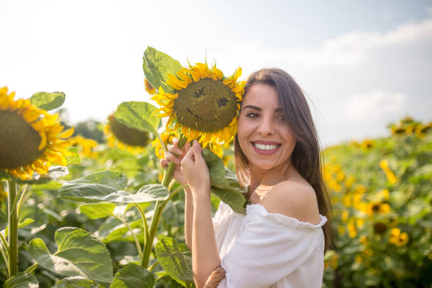 istock Woman in the sunflower field 1496708164
