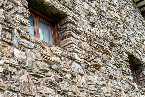 A high-resolution close-up shot of a building structure constructed of large,  rough-hewn stones