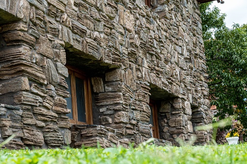 A high-resolution close-up shot of a building structure constructed of large,  rough-hewn stones