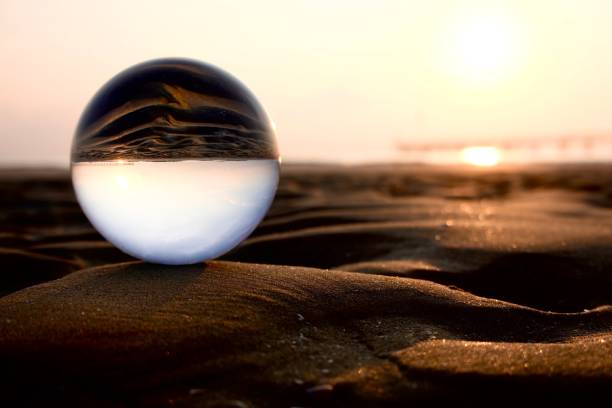 istock Crystal ball on sand during sunrise 1496712288