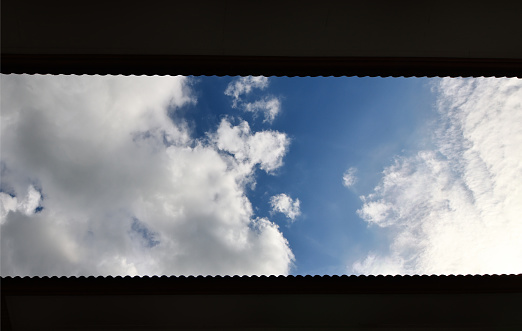 Sky seen through windows with louver shutters