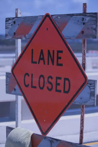 Traffic sign with the words lane closed