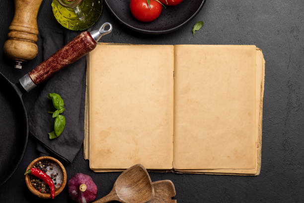 istock Top-down view of a kitchen table with ingredients, utensils, and an open cookbook 1496715028