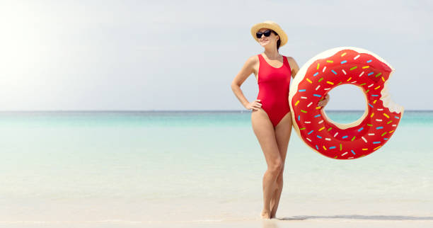 istock Beautiful woman with inflatable donut 1496717819