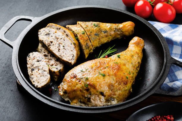 istock Baked Stuffed Chicken Legs in a Pan on Dark Backround 1496717975
