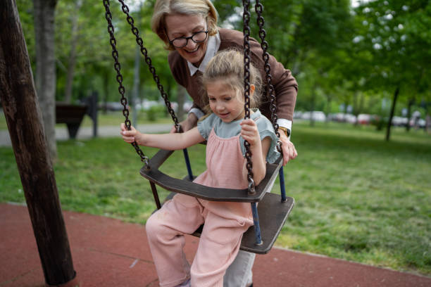 istock Little girl swinging on a swing 1496718649