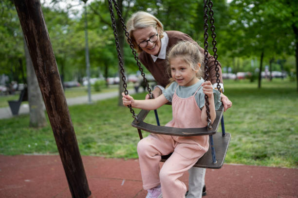 istock Little girl enjoys swinging 1496718721