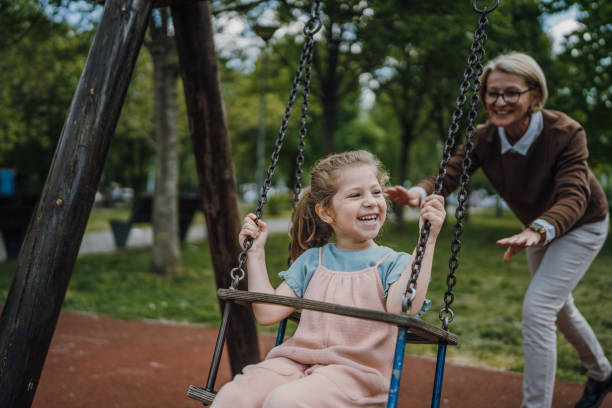 istock Little girl swinging on a swing 1496718980