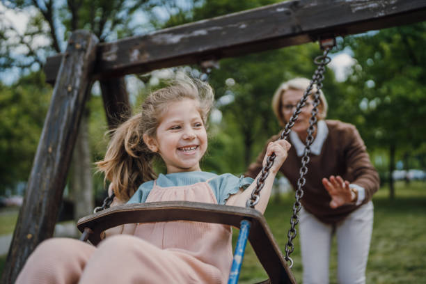 istock Little girl swinging in park 1496718997