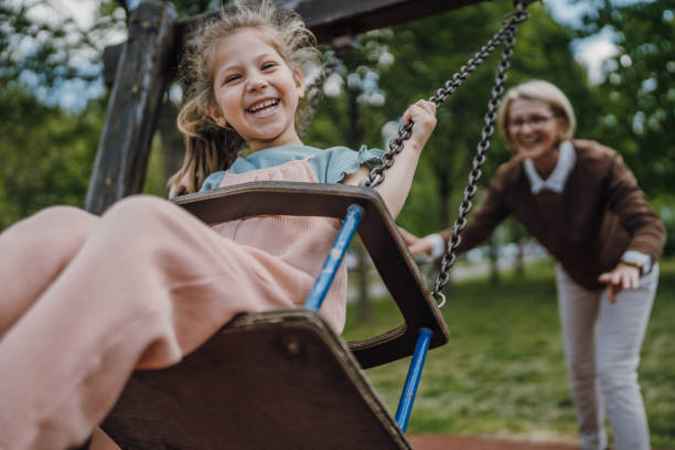 istock Little girl swinging in park 1496719017