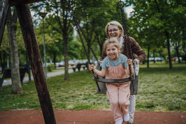 istock Cute girl swinging in park 1496719047