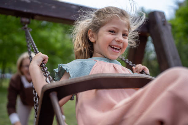 istock Cute girl swinging 1496719695