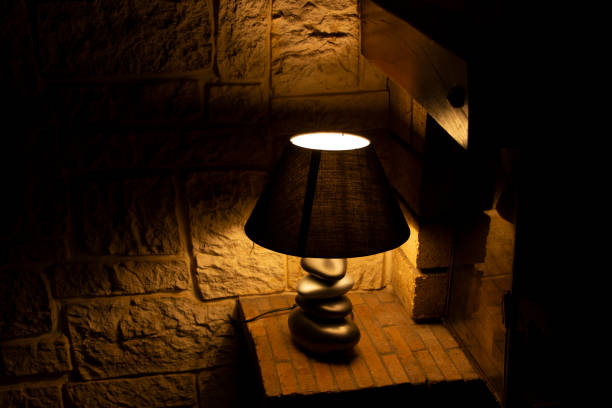 istock Floor lamp and lampshade next to a fireplace 1496723905